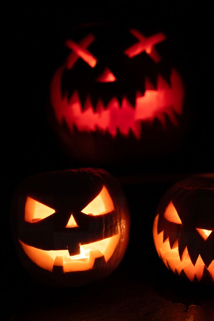 Close-up of glowing jack-o'-lanterns creating a spooky Halloween atmosphere.