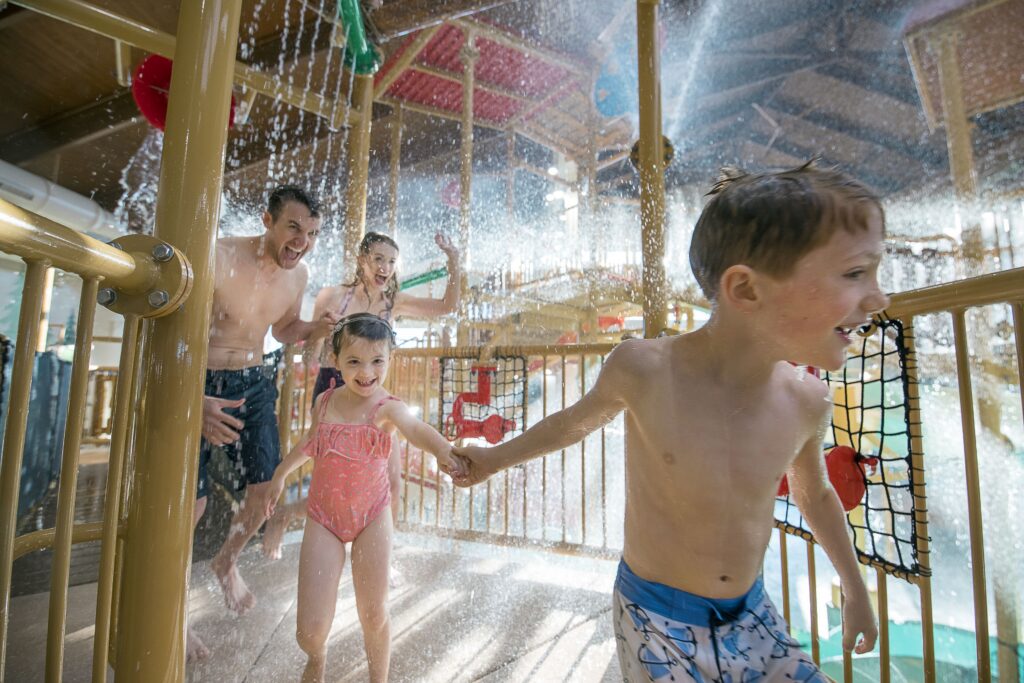 Family playing in the indoor water park at Great Wolf Lodge Grapevine
