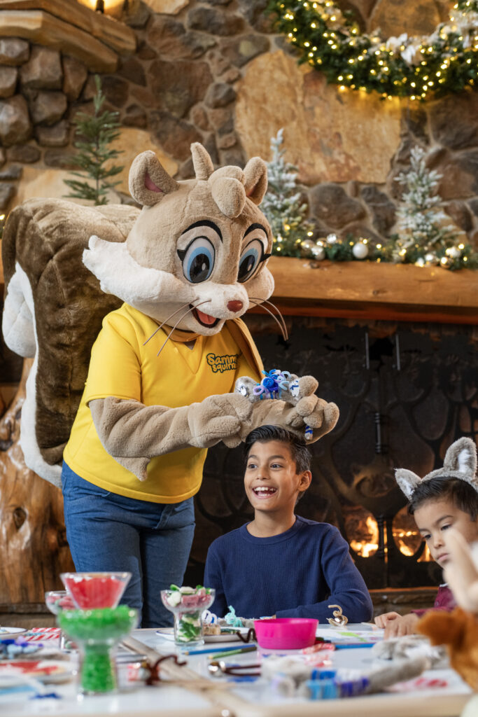 Kids doing a holiday craft with Sammy Squirrel during Snowland at Great Wolf Lodge